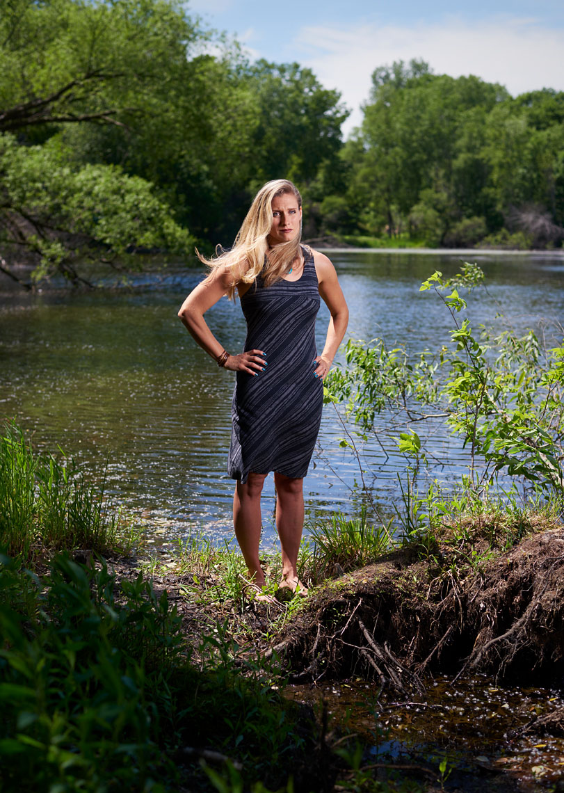 Barefoot cult survivor portrait in woods by lake