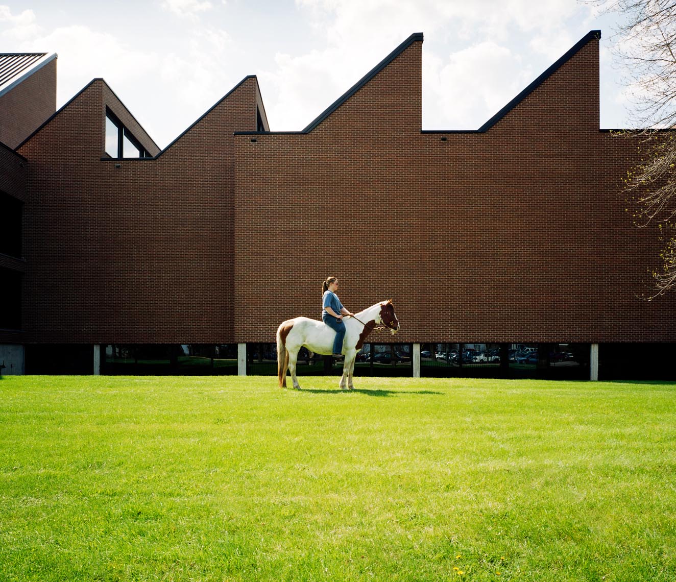 College student with horse on campus portrait